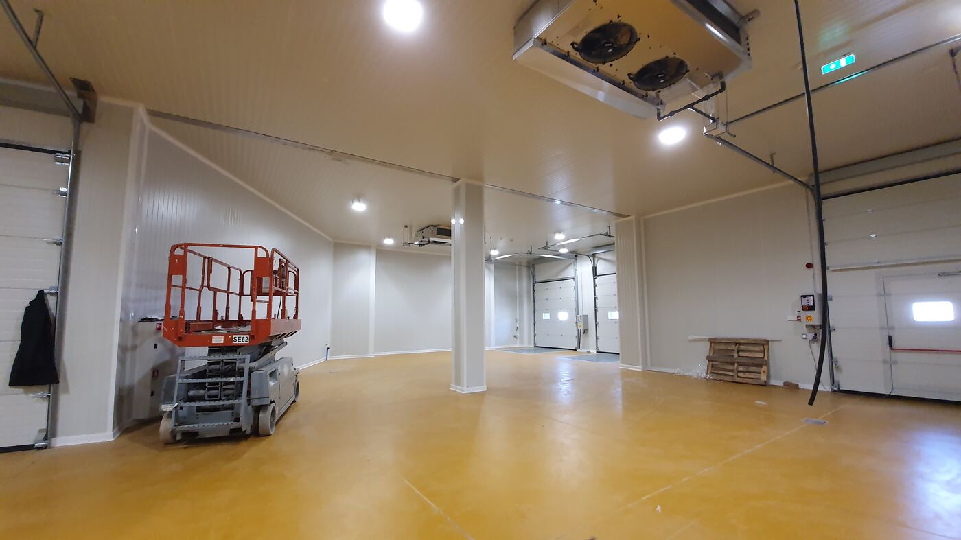 Large cold storage warehouse shell with insulated panels and dock doors